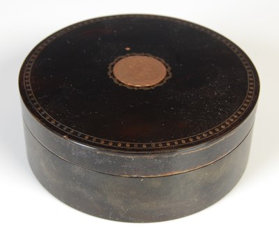 Lot 146 - A George III yellow metal inlaid tortoiseshell circular shaped box and cover