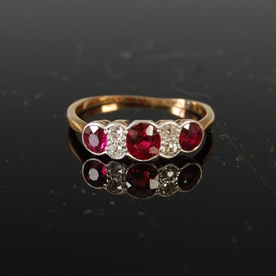 Lot 505 - An early 20th century yellow and white metal ruby and diamond set half-hoop ring