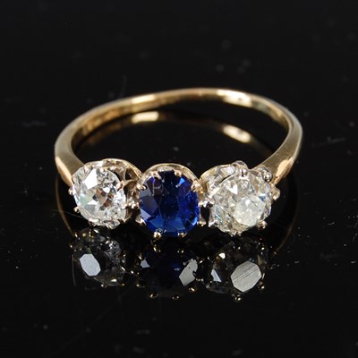 Lot 517 - A mid 20th century yellow and white metal sapphire and diamond three stone ring