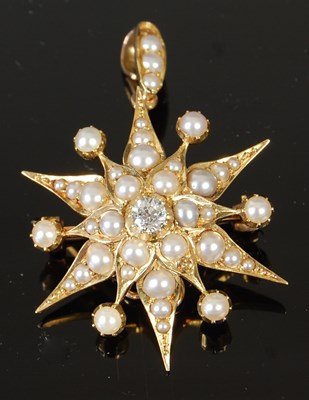 Lot 525 - A Victorian yellow metal, pearl and diamond set star brooch