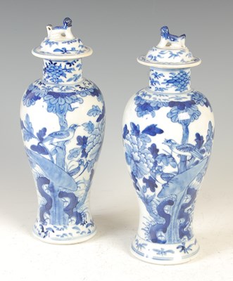 Lot 655 - A pair of Chinese porcelain blue and white jars and covers, Qing Dynasty