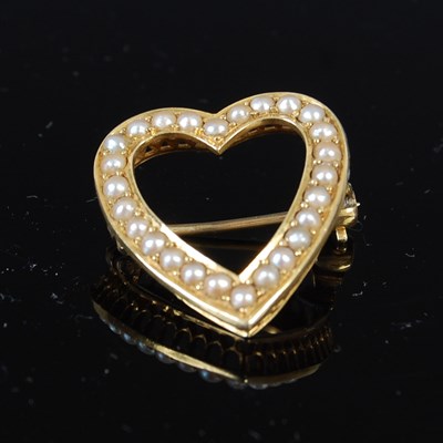 Lot 484 - A yellow metal and split pearl heart shaped brooch, late 19th / early 20th century