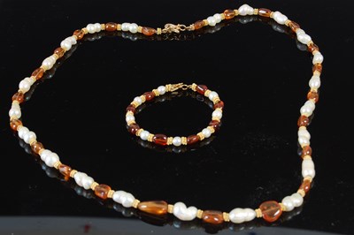 Lot 481 - A 20th century Indian suite of freshwater pearl, amber and yellow metal jewellery