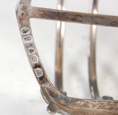 Lot 412 - A Victorian silver seven bar toast rack, London, 1856, makers mark of CTF. over GF.
