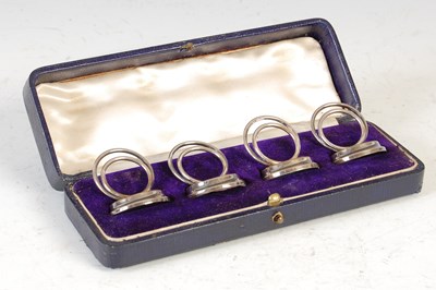 Lot 397 - A set of four George V silver place card holders, Chester, 1911