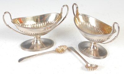 Lot 409 - A pair of Victorian silver canoe shaped salts and original corresponding salt spoons