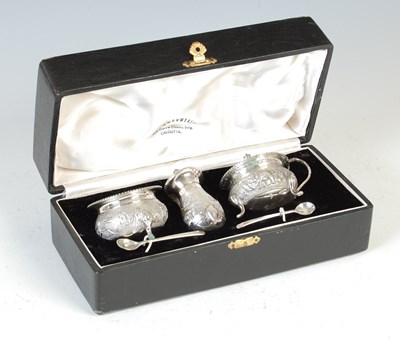 Lot 394 - A late 19th / early 20th century Indian sterling silver three-piece cruet set