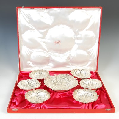 Lot 428 - A set of seven Middle Eastern white metal lotus shaped bowls, 20th century