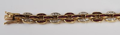 Lot 527 - A 20th century Art Deco style yellow metal, ruby and diamond set bracelet