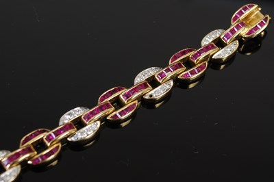 Lot 527 - A 20th century Art Deco style yellow metal, ruby and diamond set bracelet