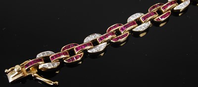 Lot 527 - A 20th century Art Deco style yellow metal, ruby and diamond set bracelet