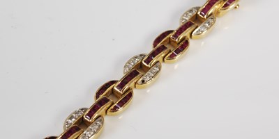 Lot 527 - A 20th century Art Deco style yellow metal, ruby and diamond set bracelet