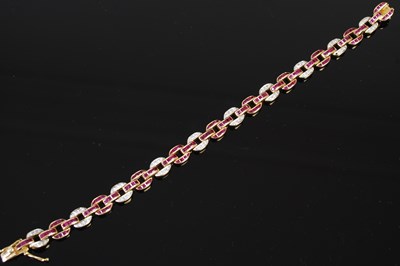 Lot 527 - A 20th century Art Deco style yellow metal, ruby and diamond set bracelet