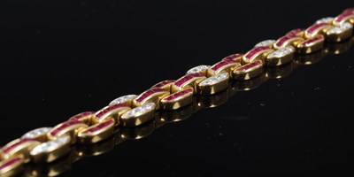 Lot 527 - A 20th century Art Deco style yellow metal, ruby and diamond set bracelet