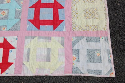 Lot 184 - A late 19th / early 20th century pink ground patchwork quilt