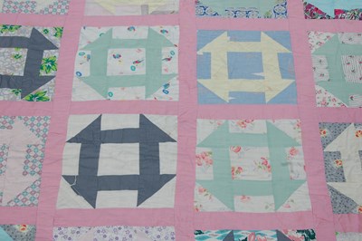 Lot 184 - A late 19th / early 20th century pink ground patchwork quilt