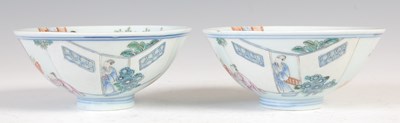 Lot 677 - A pair of Chinese porcelain famille rose footed bowls, Qing Dynasty, bearing Qianlong seal marks