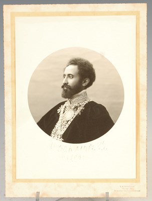 Lot 200 - A sepia toned portrait photograph of Haile Selassie 1892-1975