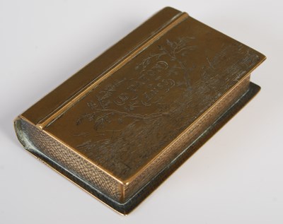 Lot 205 - An unusual brass snuff box in the form of a book