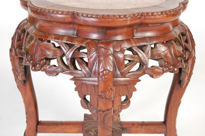 Lot 8 - A Chinese dark wood urn stand, early 20th century