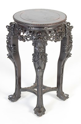 Lot 31 - A Chinese dark wood urn stand