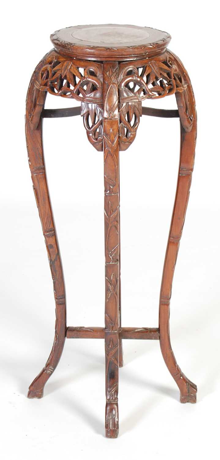 Lot 44 - A Chinese dark wood urn stand, Qing Dynasty