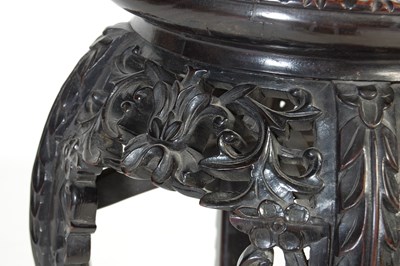 Lot 21 - A Chinese dark wood urn stand, Qing Dynasty