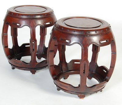 Lot 100 - A pair of Chinese dark wood barrel-shaped stools, late 19th/ early 20th century