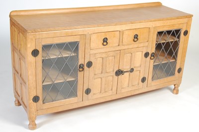 Lot 29 - An oak sideboard in the manner of Robert 'Mouseman' Thompson