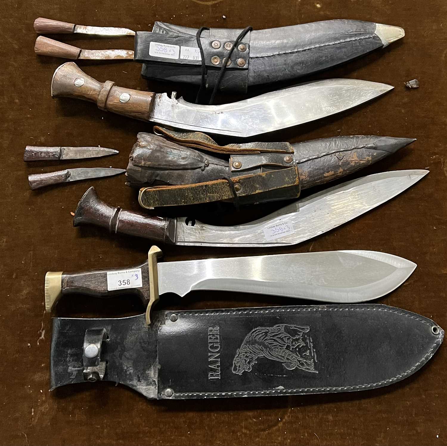 Lot 358 - Two vintage kukri knives each with companion...