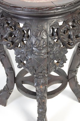 Lot 9 - A Chinese dark wood urn stand, Qing Dynasty,...