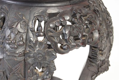 Lot 9 - A Chinese dark wood urn stand, Qing Dynasty,...