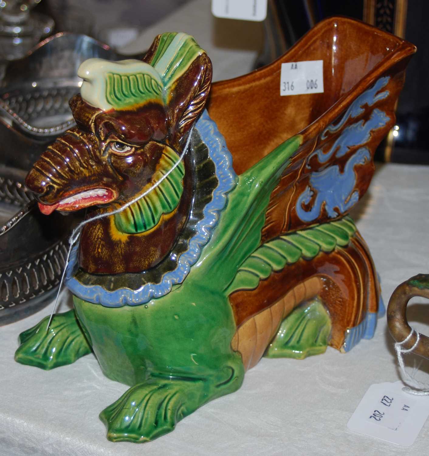 Lot 552 - A Shiwan style pottery dragon form planter.