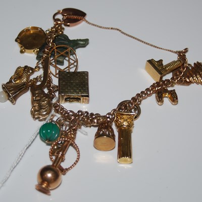 Lot 58 - A 9ct gold charm bracelet suspending...