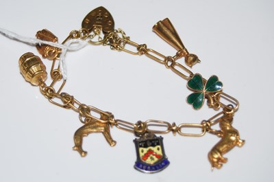 Lot 67 - A 9ct gold charm bracelet suspending six...