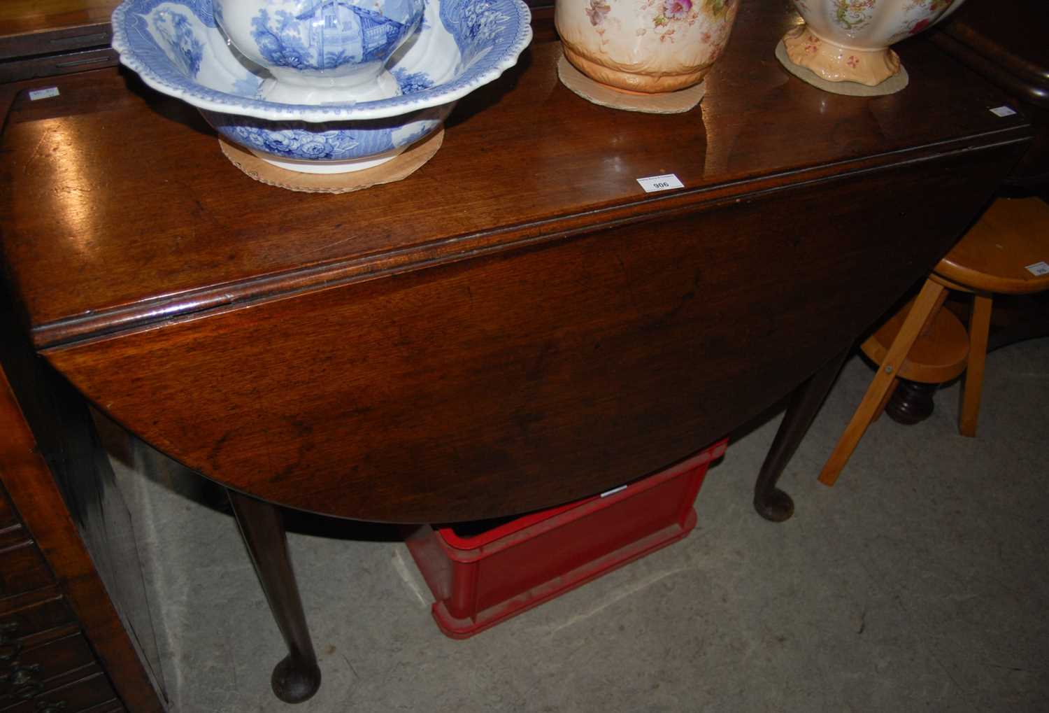 Lot 906 - A 19th century mahogany drop-leaf table raised...