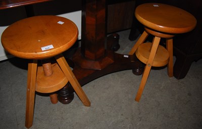 Lot 910 - A pair of pine adjustable stools.