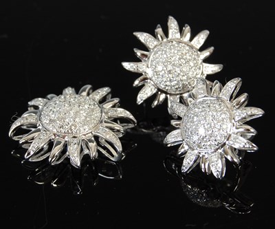 Lot 446 - A white metal and diamond flower shaped...