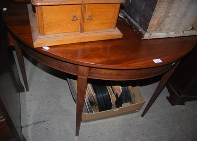 Lot 914 - A mahogany demi lune console table, the lower...