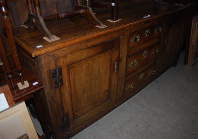 Lot 923 - A George III oak dresser base, centred with...