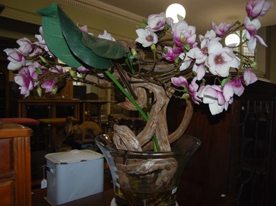 Lot 931 - A faux plant mounted in a large glass vase...
