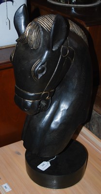 Lot 943 - An ebonised carved bust of a horse with gilt...