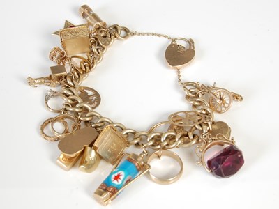 Lot 457 - A 9ct gold charm bracelet, suspending twenty...