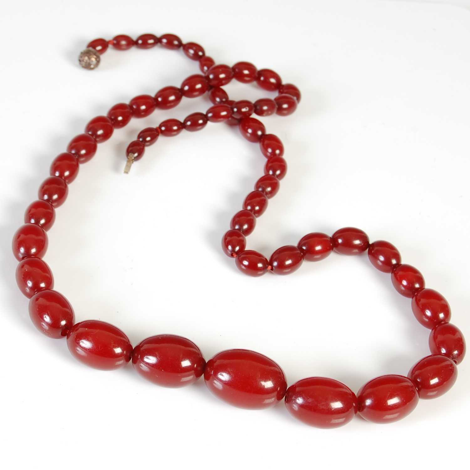 Lot 458 - A red amber type necklace, formed from a...