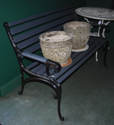 Lot 954 - A black painted wrought metal garden bench...