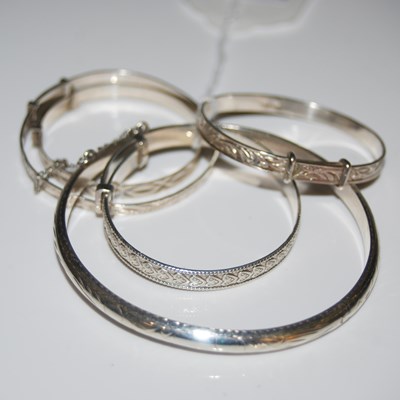 Lot 104 - A collection of assorted white metal bangles/...