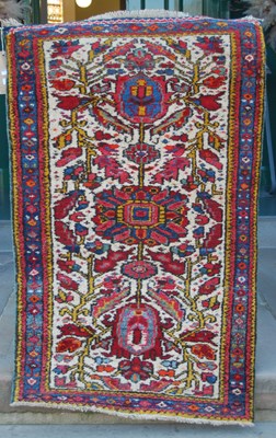 Lot 1057 - Two small Persian rugs, comprising a brown...