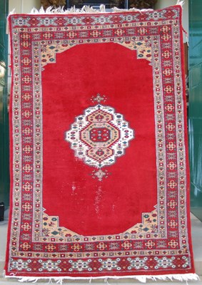 Lot 1061 - A Persian rug, 20th century, the madder ground...