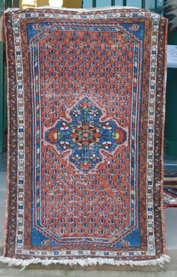 Lot 1070 - A Persian mat, early 20th century, the madder...