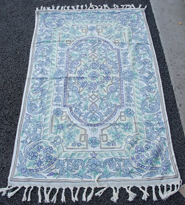 Lot 963 - A white ground tasseled rug with repeating...